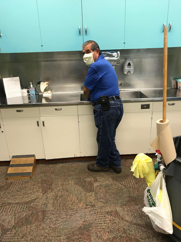person cleaning sink