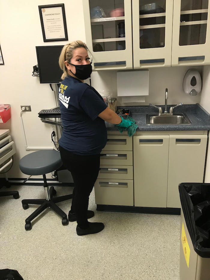 person cleaning sink