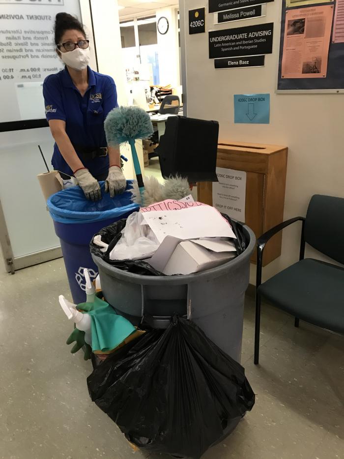 person pushing cleaning cart